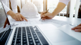 Image of engineer meeting for architectural project. working with partner and engineering tools on workplace vintage tone.